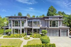 a large house with lots of windows and landscaping