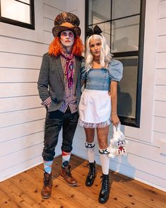 two people dressed up in costumes standing next to each other