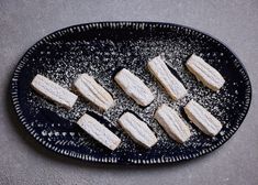 several pieces of food on a black plate