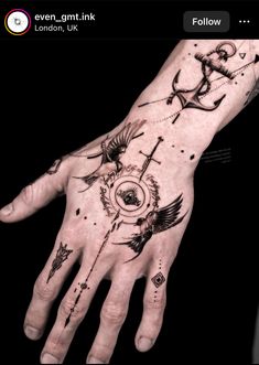 a person's hand with tattoos on it and an anchor tattoo on the palm