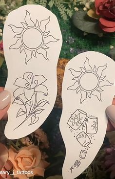 someone is holding up some stickers with sun and flowers on them