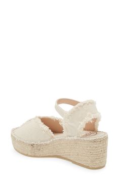 A woven platform and wedge heel underscore the espadrille-inspired style of this summery sandal finished with frayed trim. 2 1/2" heel, 1 1/2" platform (size 39w) Textile upper/synthetic lining and sole Made in Spain Summer Platform Espadrilles In Natural Color, Natural Platform Espadrilles For Summer, Summer Natural Platform Espadrilles, Summer Natural Color Platform Espadrilles, Closed Toe Platform Espadrilles For Vacation, Cream Espadrille Sandals For Summer, Summer Cream Platform Espadrilles, Cream Espadrille Sandals For Vacation, Cream Platform Espadrilles For Vacation