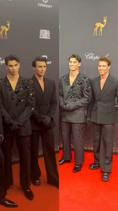 the men are posing for pictures on the red carpet