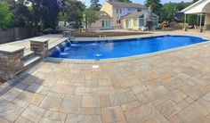 a large swimming pool with steps leading up to it and a fire pit in the middle