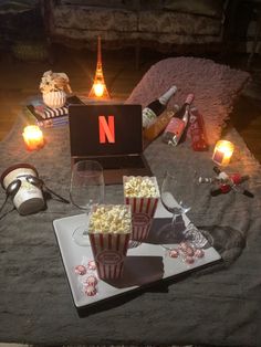 a laptop and some popcorn on a table