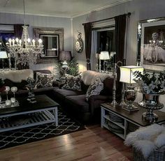 a living room filled with furniture and chandeliers on top of wooden flooring