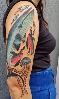 a woman with a fish tattoo on her arm