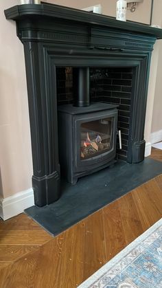 a fireplace with a wood burning stove in it