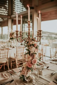 an elegant centerpiece with flowers and candles