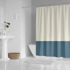 a white and blue bathroom with a shower curtain