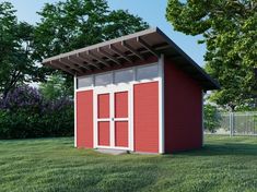 a red and white shed sitting on top of a lush green field next to trees