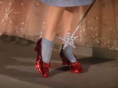 a close up of a person's red shoes with a star decoration on them