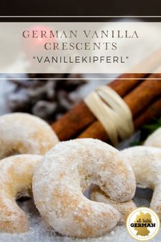 some sugared doughnuts and cinnamon sticks on a table