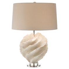 a lamp that is on top of a table with a white cloth shade over it