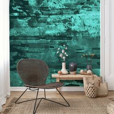 a chair and table in front of a green wall