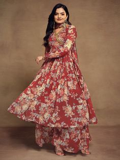 Indulge in the timeless allure of our ravishing red chiffon suit, adorned with exquisite floral print, zari work, and sequin detailing. This ensemble encapsulates the essence of elegance and sophistication, with its vibrant red hue and delicate embellishments. Crafted from high-quality chiffon material, it offers a luxurious feel and a flattering drape, ensuring both comfort and style.
Accompanying this stunning suit is a matching chiffon palazzo, intricately designed with floral print work to c Elegant Lehenga In Georgette With Printed Motifs, Elegant Georgette Lehenga With Printed Motifs, Elegant Lehenga With Printed Motifs In Georgette, Elegant Lehenga With Printed Motifs, Elegant Georgette Sharara With Printed Motifs, Diwali Floral Print Georgette Sets, Elegant Floral Print Georgette Sharara, Bollywood Style Floor-length Floral Print Set, Elegant Georgette Sets With Floral Print