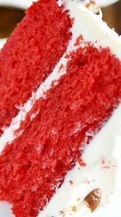 a slice of red velvet cake with white frosting