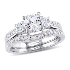 an engagement ring set with three stones on the side and two bands around the band