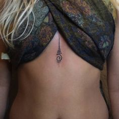 a woman with a tattoo on her back showing the lower part of her stomach and an arrow