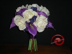 a bouquet of white and purple flowers on a table