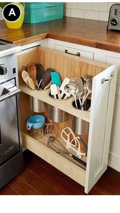 an open cabinet in a kitchen filled with utensils