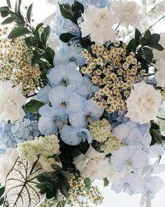 a vase filled with blue and white flowers