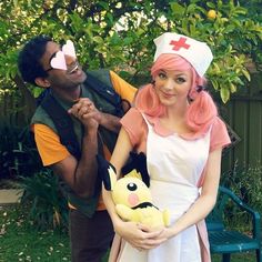 a man and woman dressed up as pokemon characters, one holding a pikachu doll