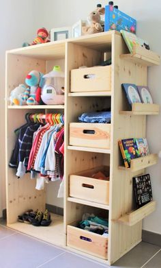 a wooden shelf with baskets and clothes on it