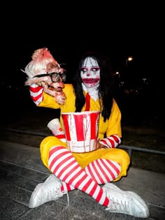 a person dressed as a clown holding a bucket