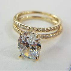 a close up of a ring with a diamond on it's center and two bands around the band