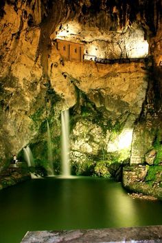 a small waterfall in the middle of a cave