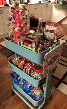 a cart filled with candy and candies on top of a hard wood floored floor