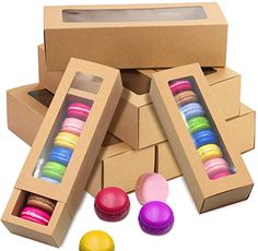 an open cardboard box filled with different colored macaroons