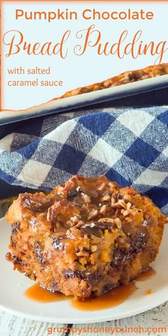 pumpkin chocolate bread pudding with salted caramel sauce on a white plate next to a blue and white checkered towel