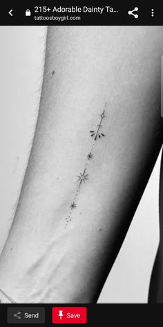 a woman's arm with an arrow tattoo on it