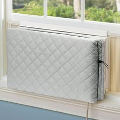 a white mattress sitting on top of a window sill