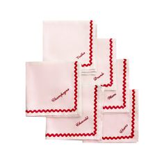 four red and white napkins with scalloped edges