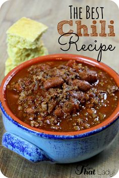 chili recipe in a blue bowl with bread on the side and text overlay that reads chili recipe