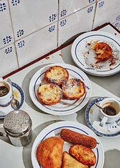 three plates with pastries and coffee on a table