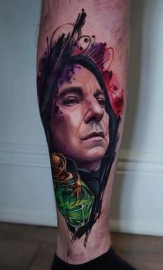 a man's leg with a tattoo on it and his face painted in watercolor