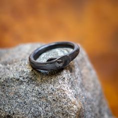 Hand Forged Iron Ring  This ring is made from iron. Forged both round and flat secured together with a iron pin and beautifully textured by the hammer. You will get a custom ring since they are handmade there a not two alike. The natural color of Iron is grey-silver. The iron is darkend the traditional way by burning it in linseed oil. The iron piece will get patina. The natural color shinning through. Some more and some faster, it depends on the wearer.  If Your Size Isn't On The List Don't Hes Hand Forged Engraved Promise Ring, Adjustable Hand Forged Engraved Ring, Hand Forged Round Band Promise Ring, Hand Forged Round Band Rings For Promise, Minimalist Hand Forged Engraved Ring, Hand Forged Adjustable Round Band Ring, Adjustable Hand Forged Round Band Ring, Rustic Hand Forged Promise Ring, Hand Forged Open Promise Ring