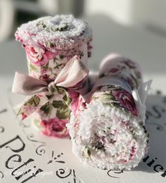 two rolled up flowers on top of each other