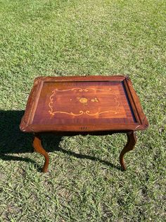 an old wooden table sitting in the grass