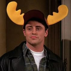 a young man wearing a moose's antlers hat