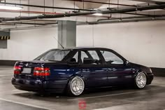 a blue car parked in a parking garage