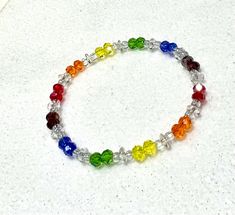 This lovely rainbow bracelet is perfect for LGBTQ Pride month. American made in the USA. Pick them up today! 🏳️🌈 Measurements  This bracelet measure approx. 8 or 8.5 inches in length 🏳️🌈 Materials This handcrafted bracelet is made with 6mm glass beads and 6/0 iridescent glass bead on stretch bead cord 🏳️🌈 We have several other LGBTQ Gay, Lesbian, Trans, Bi, Pan & Poly styles. Click here to see all of our dazzling jewelry items: https://etsy.me/2Ow7riS Rainbow Adjustable Stretch Bracelet, Adjustable Rainbow Stretch Bracelet, Adjustable Rainbow Friendship Bracelets For Birthday, Adjustable Rainbow Stretch Bracelet, Spiritual Style, Adjustable Rainbow Stretch Bracelet Spiritual, Adjustable Rainbow Beaded Crystal Bracelet, Adjustable Rainbow Spiritual Stretch Bracelet, Rainbow Hypoallergenic Jewelry For Friendship, Multicolor Pride Bracelets As A Gift