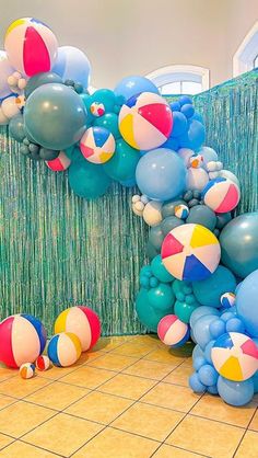 balloons and beach balls on the floor in a room