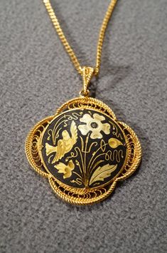 I am offering this fabulous vintage yellow gold tone necklace. This piece is truly gorgeous, and it has the following features: * beautiful vintage necklace * yellow gold tone * jet black enameled * flower design * pendant measuring 1.5 inches in diameter * 19 inches in length This is a fantastic and classic piece. There is tons of sparkle and shine with this piece. It will beautifully complement your upcoming fashion season. Buyer pays all shipping and handling. Victorian Enamel Yellow Gold Necklace, Victorian Yellow Gold Enamel Necklace, Victorian Style Yellow Gold Enamel Necklace, Yellow Gold Enamel Medallion Necklace, Antique Yellow Gold Enamel Necklace, Victorian Gold Enamel Necklace, Gold Enamel Medallion Necklace, Victorian Enamel Medallion Necklaces, Antique Enamel Locket Necklace