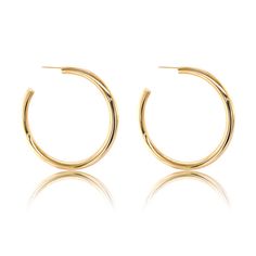 These 14K Gold Lana Hoops are expertly crafted in 14K yellow gold for a classic look. They feature a 4mm gauge and are available in 50mm, 30mm, 25mm and 20mm diameters, with a hollow design that's lightweight and comfortable for everyday wear. All sizes except 50mm feature omega clasps. 50mm have posts with backings. Sold as a pair only Hollow Design, Affordable Luxury, Chain Link Necklace, Link Necklace, Classic Looks, Gold Earrings, Diamond Necklace, Chain Necklace, Everyday Wear