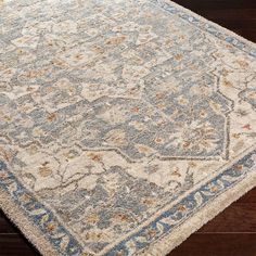 a blue and white rug with an intricate design on the bottom, sitting on a wooden floor